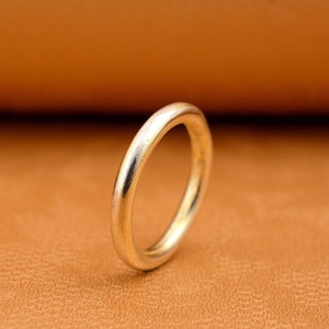 May include: A simple, silver band ring. The ring is smooth and has a polished finish.