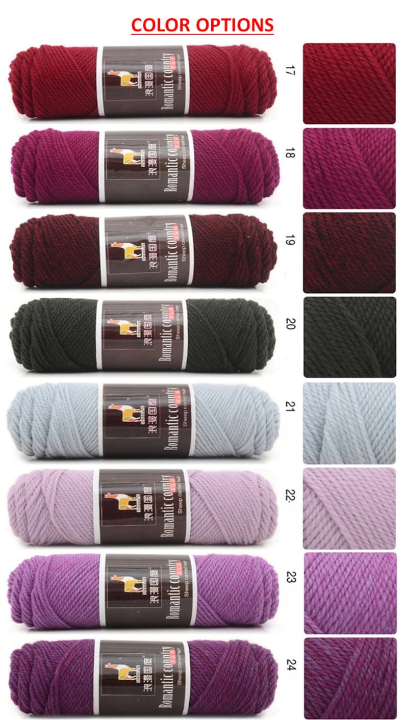 May include: A selection of yarn skeins in various colors, including red, purple, black, gray, and light pink. The yarn is labeled "Romantic Country" and is made of sheep camel hair.
