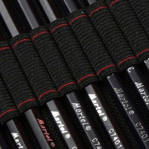 May include: Close-up of a black pencil case with black pencils labeled "Martol C7401" in white lettering. The pencils are held in place by black elastic bands with red stitching.
