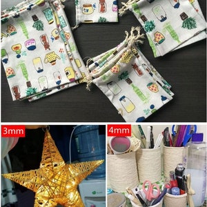 May include: A set of small, white fabric drawstring bags with a colorful pattern of teacups, plants, and jars. The bags are stacked and arranged on a white surface. The text "2mm" is visible in the top left corner of the image. The image also shows a star-shaped string light and a set of rope-wrapped containers.