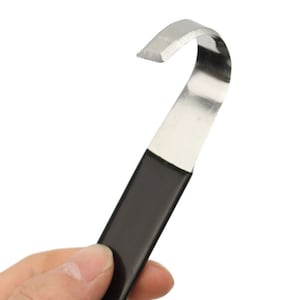 May include: A black handled tool with a curved metal blade. The tool is designed for scraping and prying.