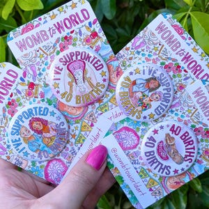 May include: Four circular pin-back buttons featuring colorful illustrations and the text "WOMB to WORLD" and "I'VE SUPPORTED 40 BIRTHS". The designs include depictions of a baby in a womb, a midwife with a newborn, and a placenta, all on white backgrounds.