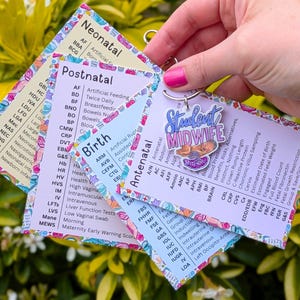May include: A set of four reference cards for midwifery students, featuring sections labelled Neonatal, Postnatal, Birth, and Antenatal with medical abbreviations and definitions. The cards are held together by a metal ring with a Student Midwife charm.