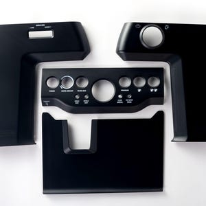 May include: A set of black plastic replacement panels and a central control interface for an espresso machine. The central panel features circular cutouts for buttons and dials, with printed labels including Power, Grind Amount, Filter Size, Program, Single, Double, Clean, and Hot Water.