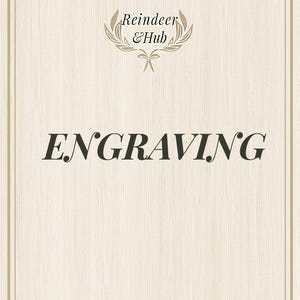 May include: A woodgrain background with a gold frame and the text "Reindeer & Hub" in a gold wreath. The text "ENGRAVING" is in black, bold font.