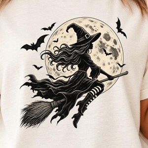 Maglietta vintage con strega volante per Halloween e grafica gotica con scopa (cotone tinto in capo)