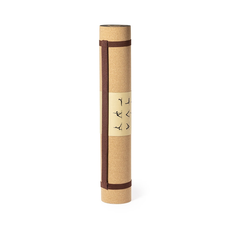 May include: Rolled cork yoga mat with a brown strap and a label featuring yoga poses. The mat is a light tan color and appears to be made of natural cork material. The strap is wrapped around the mat to keep it rolled up.