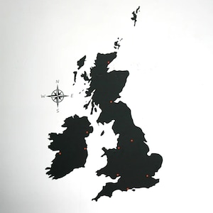 May include: A black and white map of the United Kingdom with red dots marking locations. A compass rose is in the bottom left corner.