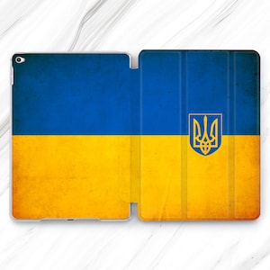 May include: A blue and yellow case for an iPad or tablet featuring a stylised image of the Ukrainian flag and coat of arms.