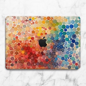 May include: A laptop case featuring a vibrant watercolor design of multicolored circles. The design transitions from red to orange, yellow, green, and blue. A black Apple logo is centered on the case. The case is designed to fit a laptop.