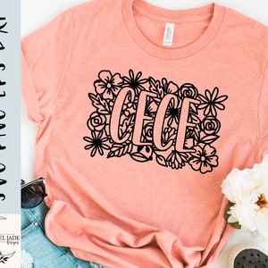 May include: A peach-colored t-shirt with a black floral design and the name "Cece" in a bold font.
