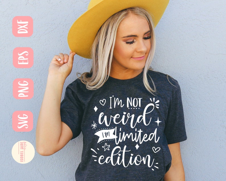 May include: A woman wearing a dark gray t-shirt with the text "I'm not weird I'm limited edition" in white. The shirt has a white heart, star, and diamond design.