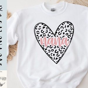 May include: White sweatshirt with a black and white leopard print heart design and the word "nana" in pink lettering.