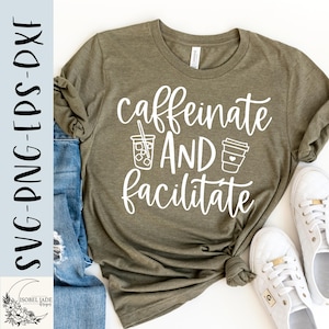 May include: Olive green t-shirt with the white text "Caffeinate AND Facilitate" and illustrations of iced coffee and a to-go coffee cup. The shirt is paired with blue jeans and white sneakers.