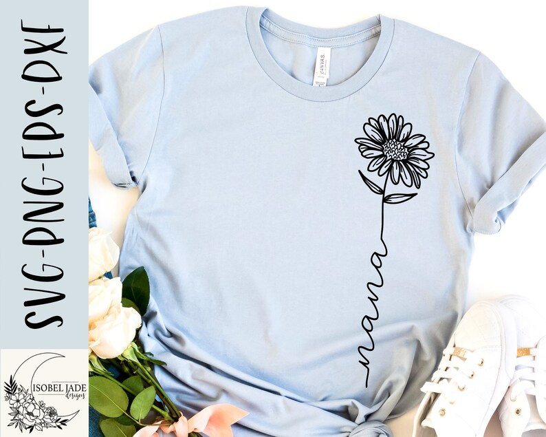 May include: A light blue t-shirt with a black line drawing of a sunflower and the word "mama" written in a script font.