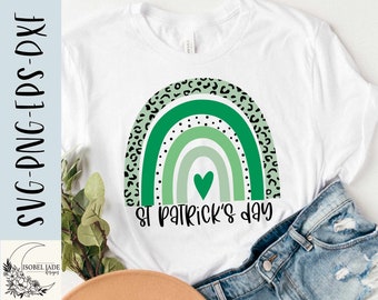May include: A white t-shirt with a green and black rainbow design and the text "St. Patrick's Day".