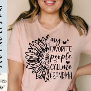 May include: A pink t-shirt with a black sunflower graphic and the text "my favorite people call me grandma".