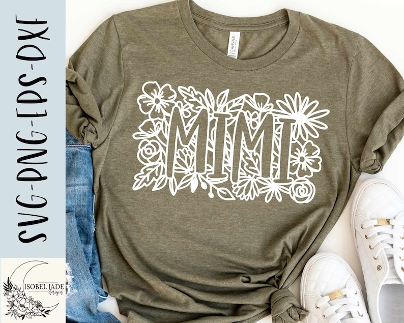 May include: A green t-shirt with a white floral design and the word "MIMI" in the center.
