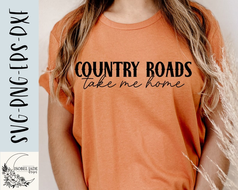 May include: A woman wearing a light orange t-shirt with the text "COUNTRY ROADS take me home" printed in black.