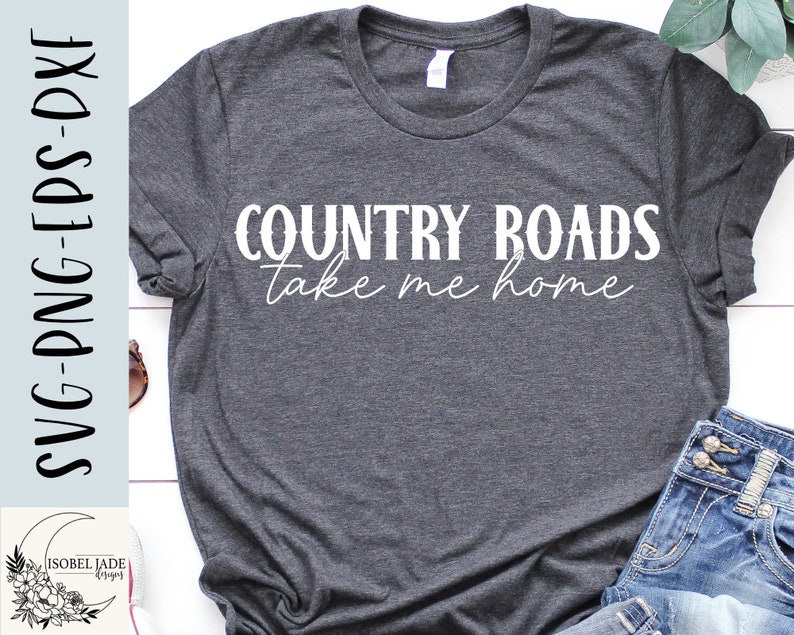 May include: A gray t-shirt with the text "COUNTRY ROADS take me home" in white lettering.