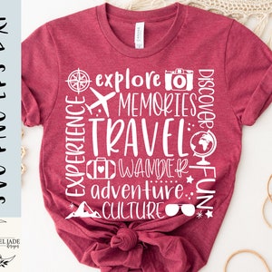 May include: Red t-shirt with white text that reads "EXPERIENCE", "explore", "MEMORIES", "TRAVEL", "DISCOVER", "FUN", "WANDER", "adventure", "CULTURE". The text is arranged in a circle around the word "TRAVEL".