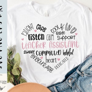 May include: White t-shirt with a pink heart design and the text "Patient Care Cool Kind Guide Listen Calm Support Teacher Assistant Sweet Committed Helpful Heart Encourage Dedicated".
