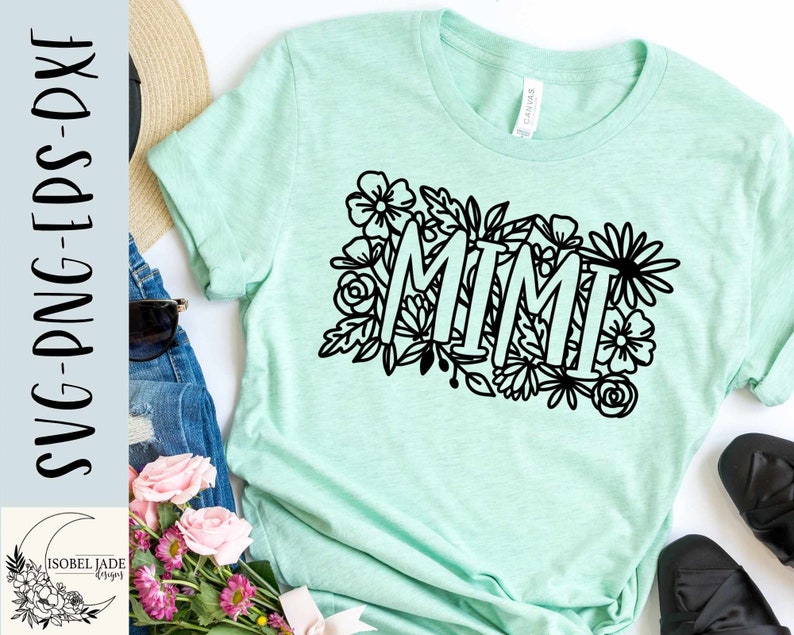 May include: A light green t-shirt with the word "MIMI" in black outlined letters surrounded by black floral designs.