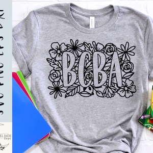 May include: A gray t-shirt with a black outline of the word "BOBA" surrounded by flowers. The design is perfect for a  t-shirt, tote bag, or sticker.
