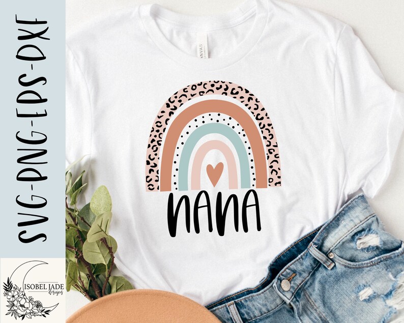 May include: A white t-shirt with a rainbow design featuring a heart in the center and the word "nana" underneath. The rainbow is made up of pink, orange, blue, and green stripes with a leopard print pattern on the outer edges.