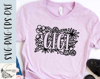 May include: A pink t-shirt with a black floral design and the word "GIGI" in the center.