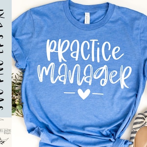 May include: A light blue t-shirt with the words "PRACTICE MANAGER" in white script, a small heart, and a horizontal line. The shirt also has the text "SVG-PNG-EPS-DXF" and the Isobel Jade Designs logo.