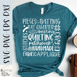 May include: Teal t-shirt with white text related to quilting. The text includes words like "Pieced", "Batting", "Fat Quarter", "Quilting", "Patchwork", "Handmade", and "Fabric Applique". The shirt also features a small logo in the bottom left corner.