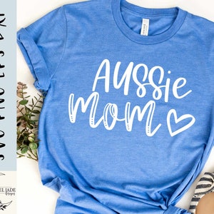 May include: A blue t-shirt with the text "Aussie Mom" in white with a white heart.