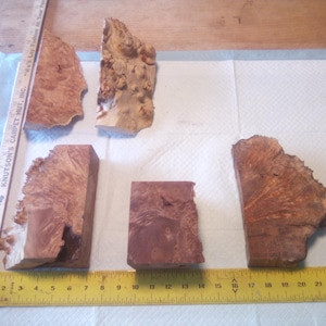 May include: A set of three ceramic mugs with a speckled, matte finish. The mugs are in shades of cream, light gray, and dark gray. Each mug has a simple, minimalist design, perfect for coffee or tea.