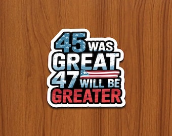 May include: A sticker with the text "45 WAS GREAT 47 WILL BE GREATER" in white, blue, and red. The numbers 45 and 47 are in blue with white stars. The word GREAT is in white with a blue outline.