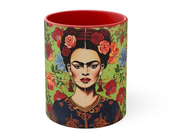May include: A red ceramic mug with a colorful image of Frida Kahlo wearing a flower crown and a blue and gold patterned dress. The background is a green floral pattern.