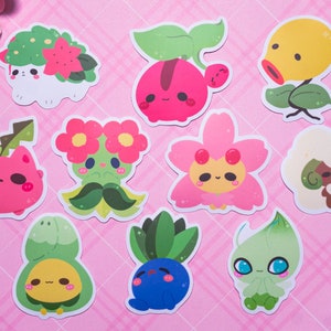 May include: A set of ten colorful cartoon stickers featuring various plant and flower characters. The stickers are on a pink background with a grid pattern.