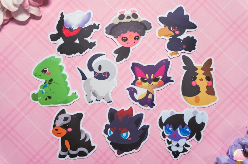 May include: A set of ten cartoon character stickers featuring various Pokemon characters. The stickers are printed on white paper and have a glossy finish. The characters include a black and white ghost-type Pokemon, a green lizard-type Pokemon, a black and white dog-type Pokemon, a black and red cat-type Pokemon, a black and yellow bird-type Pokemon, a black and white cat-type Pokemon, a black and white dog-type Pokemon, a black and red cat-type Pokemon, a black and white cat-type Pokemon, and a black and white cat-type Pokemon.