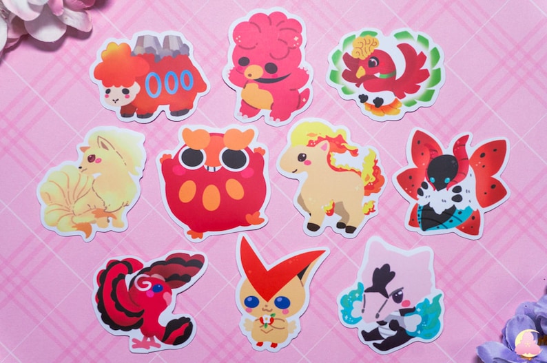 May include: Ten colorful cartoon stickers featuring various fire-type Pokemon. The stickers are printed on white paper and feature a variety of poses and expressions.