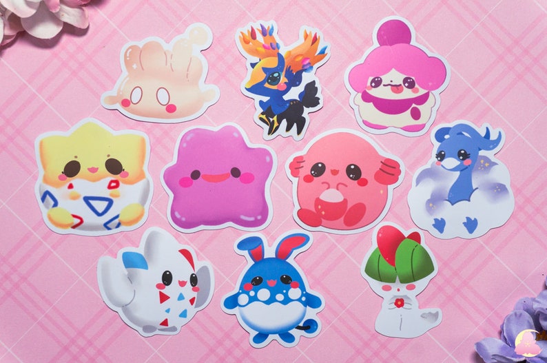 May include: A set of nine colorful cartoon character stickers featuring various Pokemon characters. The stickers are printed on white paper and have a glossy finish.