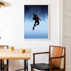 May include: A framed poster featuring a silhouette of a person in a red and black suit, with a green jacket, jumping in front of a city skyline. The background is a blue gradient with white stars.