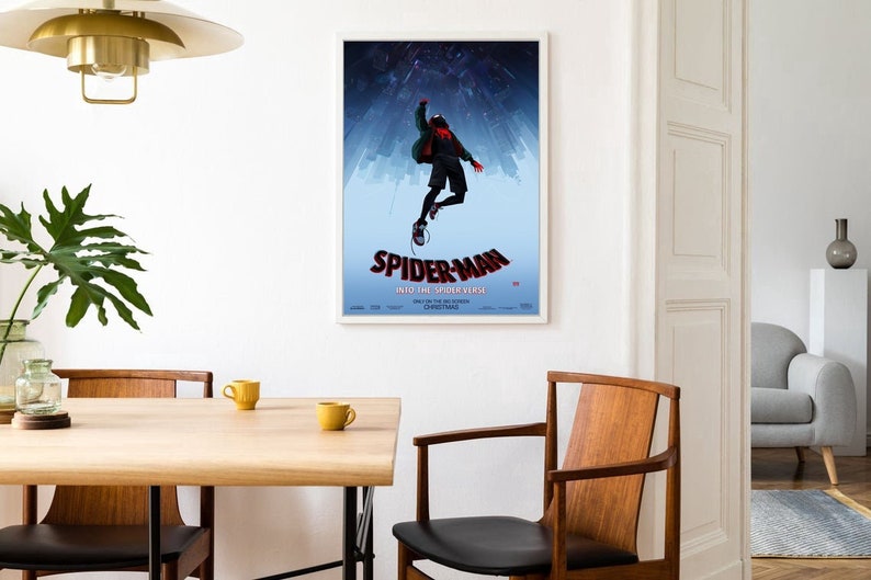 May include: A poster for the movie "Spider-Man: Into the Spider-Verse" featuring a cartoon image of Spider-Man swinging through the air in front of a cityscape.