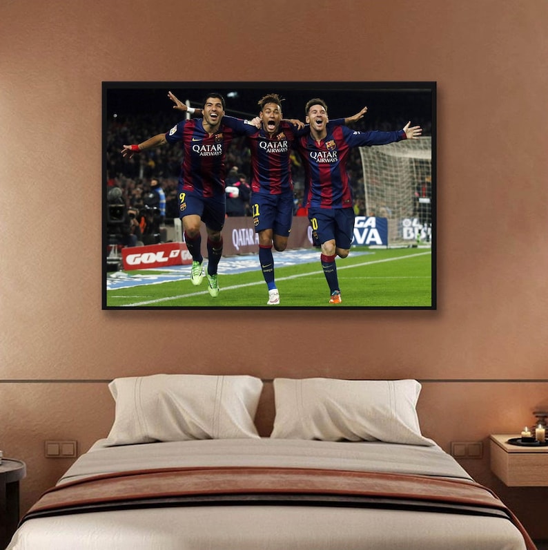 May include: Three soccer players in blue and red uniforms celebrate a goal on a green field. The players are all wearing the same jersey with the text "Qatar Airways" on the front. The players are running towards the camera with their arms raised in the air.