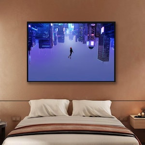 May include: A framed art print depicts a person in a red suit floating in front of an upside-down cityscape. The buildings are illuminated with neon lights in shades of blue and purple. The artwork is displayed above a bed with white pillows and a brown blanket.