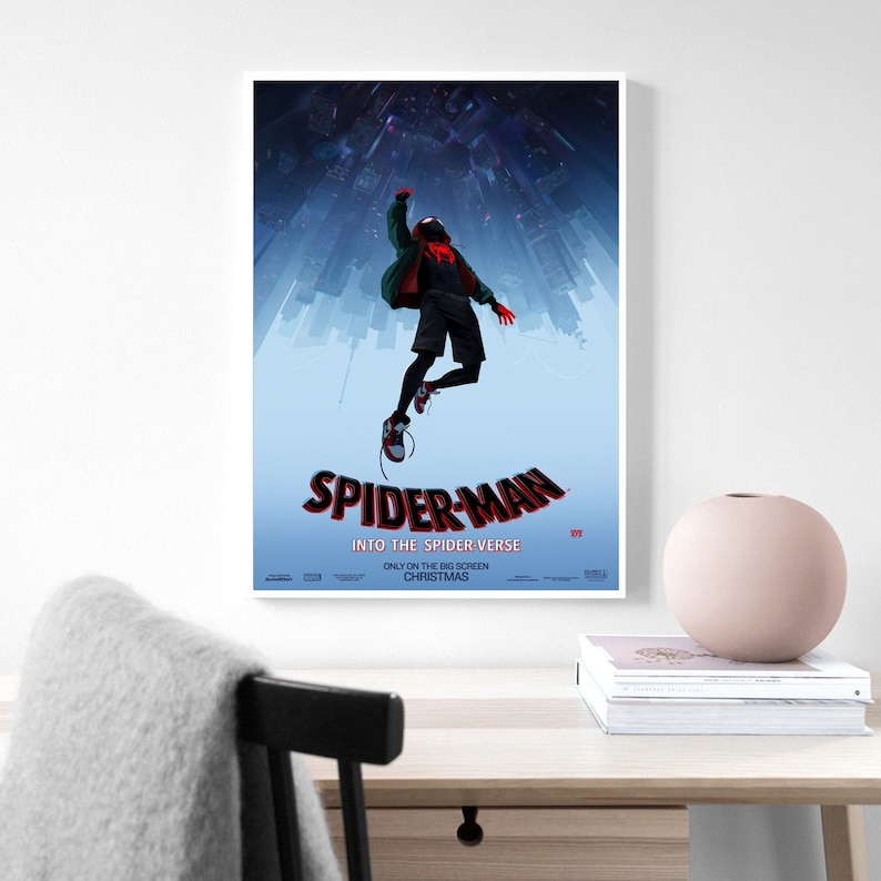 May include: A poster for the animated movie "Spider-Man: Into the Spider-Verse". The poster features a blue background with a cityscape in the background. A red and black Spider-Man is jumping in the air with his arms outstretched. The text "Spider-Man: Into the Spider-Verse" is in red and black letters at the bottom of the poster.