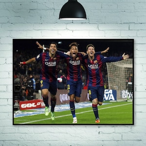 May include: Three soccer players in red and blue uniforms celebrate a goal. The players are wearing jerseys with the text "Qatar Airways" on the front. The players are on a green field with a soccer goal in the background.