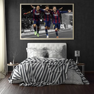 May include: Three soccer players in blue and red uniforms celebrating a goal. The players are running and raising their arms in the air. The image is in black and white except for the players' uniforms. The players are wearing jerseys that say "Qatar Airways".