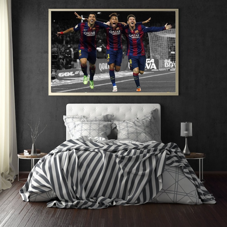 May include: Three soccer players in blue and red uniforms celebrating a goal. The players are running and raising their arms in the air. The image is in black and white except for the players' uniforms. The players are wearing jerseys that say "Qatar Airways".