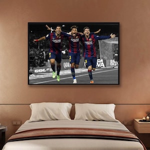 May include: Three soccer players in blue and red uniforms with the text "Qatar Airways" on their jerseys are celebrating a goal. The players are running towards the camera with their arms raised in the air. The background is black and white.
