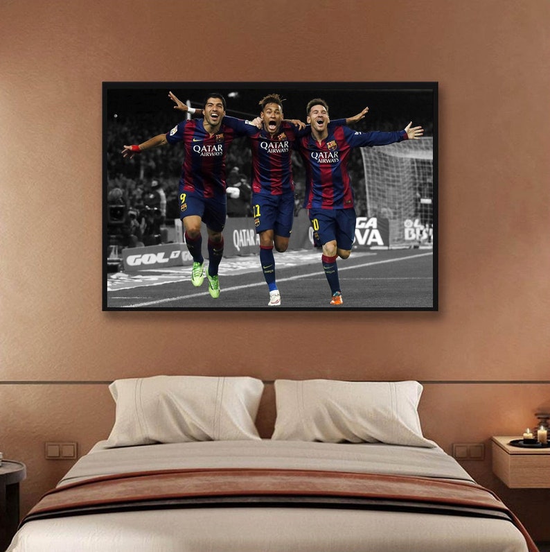 May include: Three soccer players in blue and red uniforms with the text "Qatar Airways" on their jerseys are celebrating a goal. The players are running towards the camera with their arms raised in the air. The background is black and white.